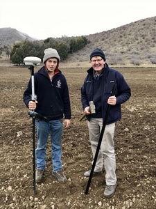 Jack Innes helping to survey post positions